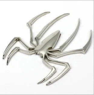 Three-dimensional metal spider bumper sticker in zinc alloy, showing gold colour option.