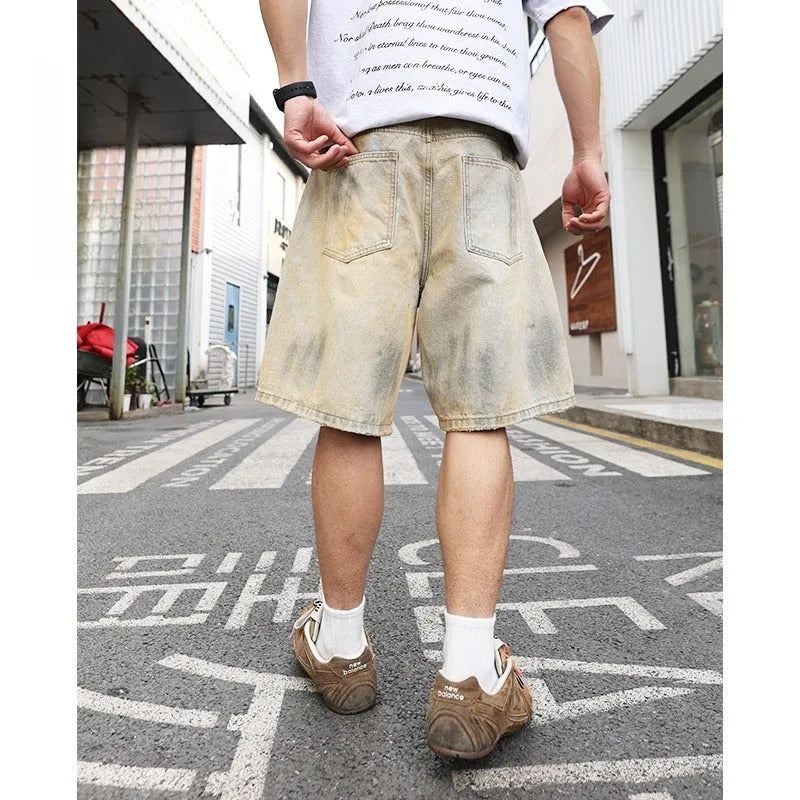 Men's light blue ripped denim shorts showing straight-leg design and mid waist fit