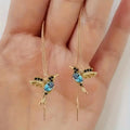 Women's long style bird hanging dangle earrings with mixed zirconium wing details in alloy construction