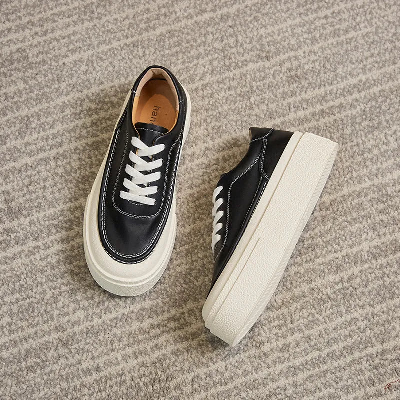 Women's black platform casual shoes with embossed cowhide texture and rubber sole