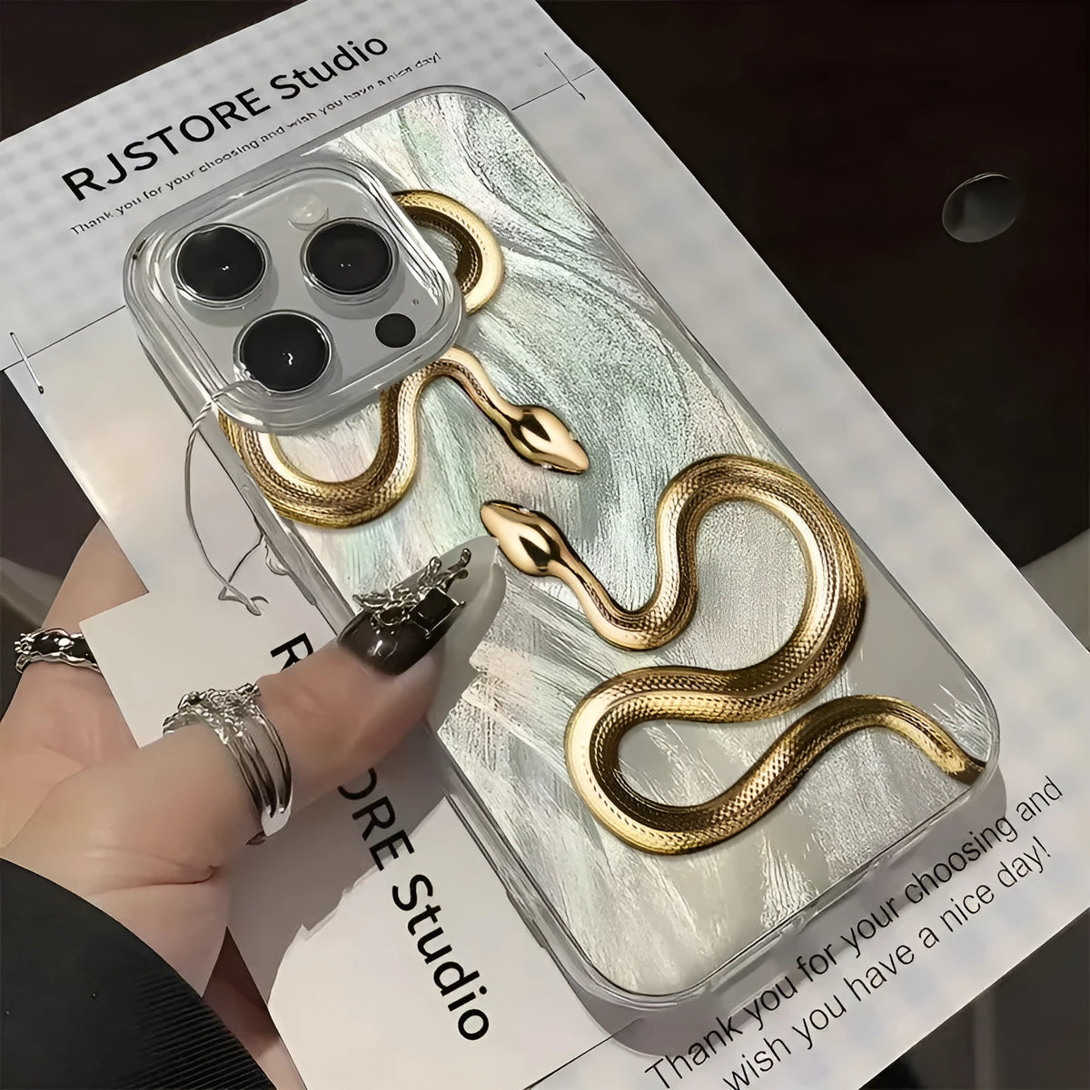 Gold snake hard PC phone case for iPhone 16 Plus with cartoon design and random back texture