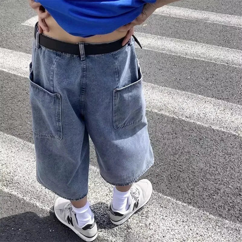 Blue washed denim shorts for men with a high waist, cropped length, and front zip fly.