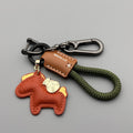 Handmade car keychain with a zinc alloy pony charm on a cowhide cord, shown in multiple colour options.