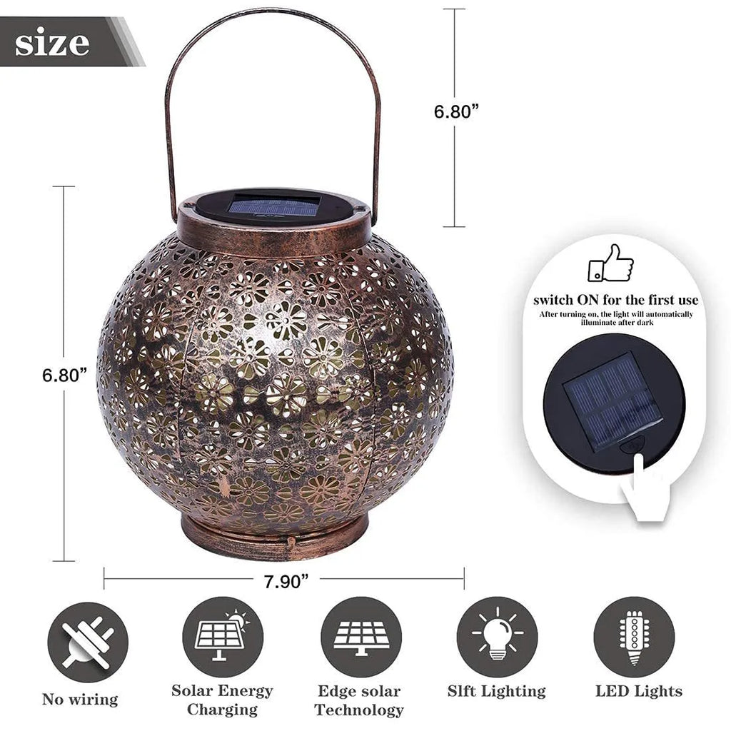 Solar wrought iron hollow flower projection lamp with warm white LED light and shadow pattern on grass
