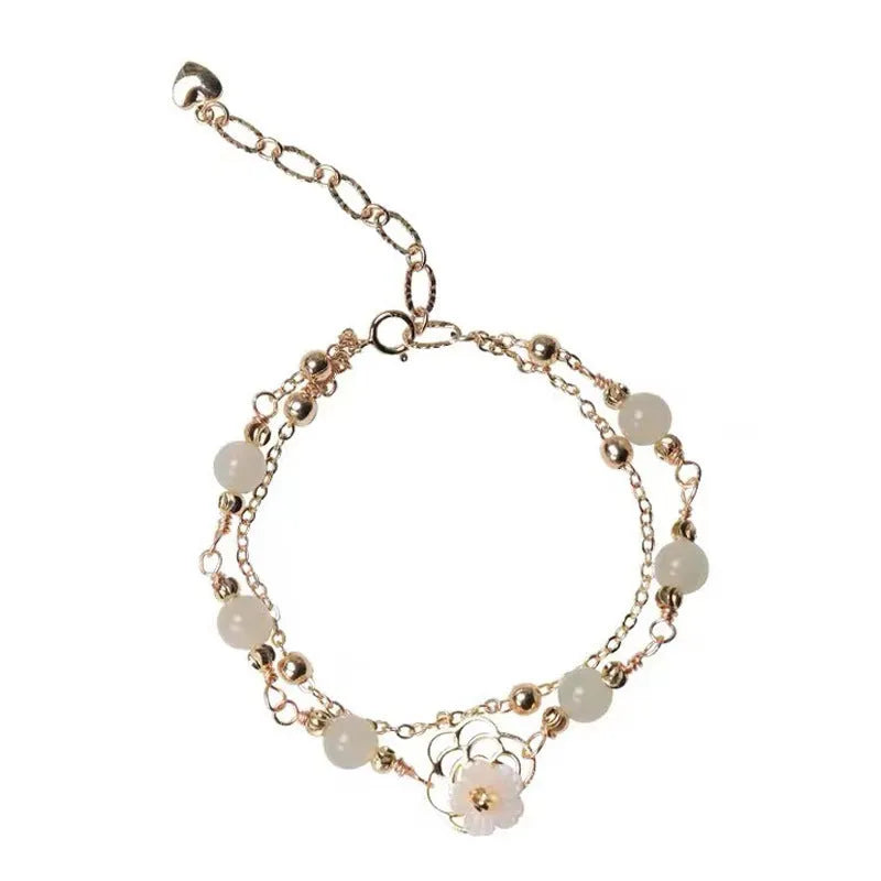 Women's yellow gold electroplated copper butterfly bracelet with geometric shell flower design and Hetian jade stone.