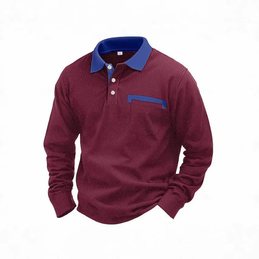 Man wearing a loose-fit long-sleeved polo shirt with a waffle knit texture in a dark blue colour.