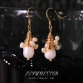 Handmade natural pearl embellished wire-wrapped earrings in geometric round shape for women