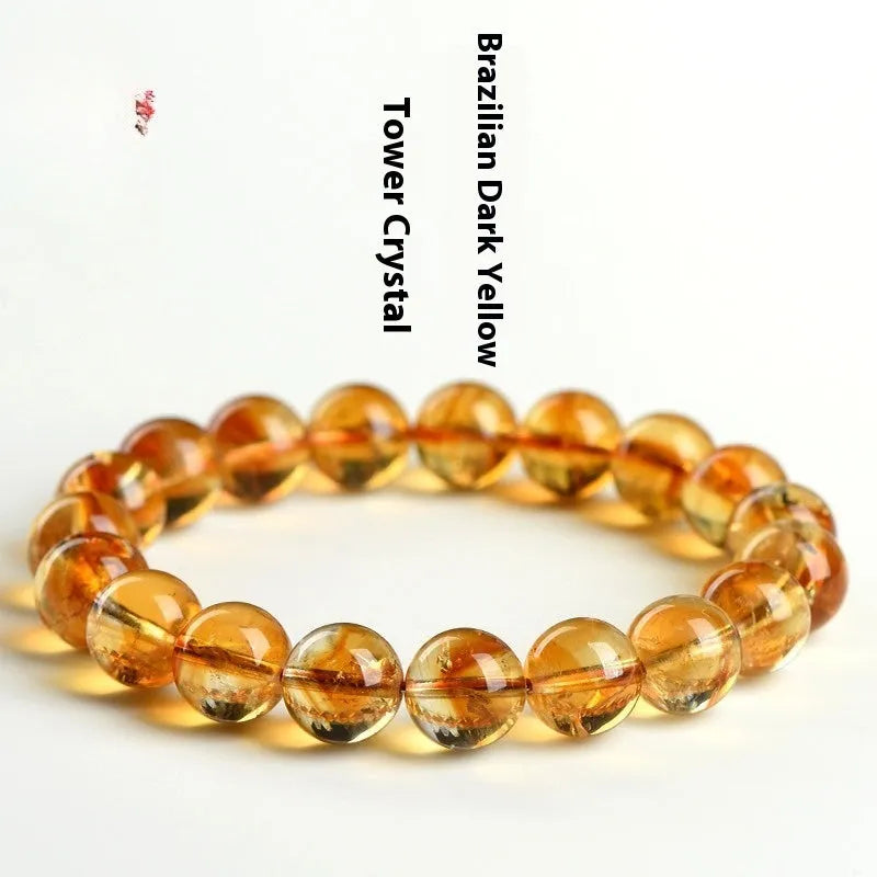 Natural yellow citrine gemstone bracelet with geometric beads on a white background.