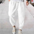 Man wearing light-coloured cotton banded ankle pants with a loose, casual fit.