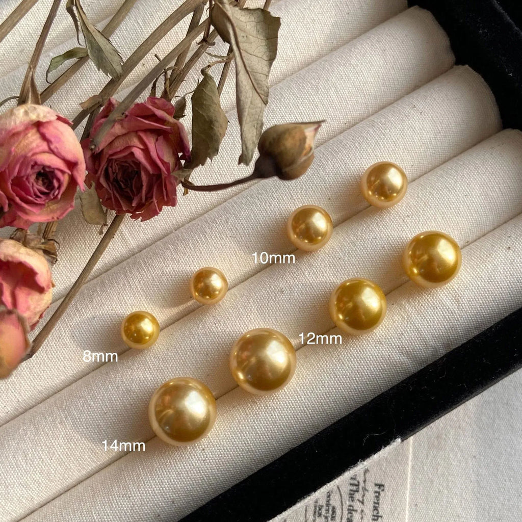 Large geometric pearl stud earrings for women in silver, showing eight-point star detail on setting.