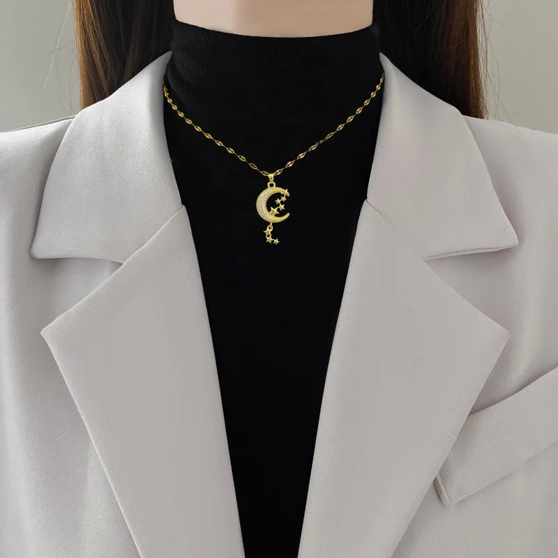 Moon tassel necklace with geometric design and diamond elements on stainless steel chain