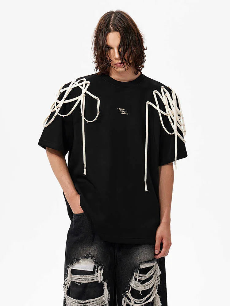 Black loose fit short sleeve t-shirt with rivet ribbon detail on padded shoulders.