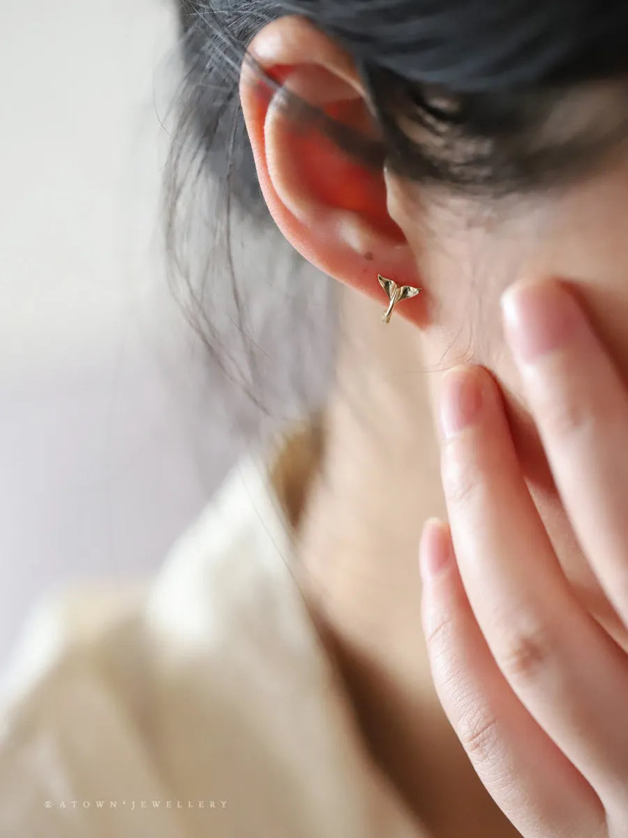 S925 sterling silver fishtail drop earrings in gold colour, showing smooth design and size.