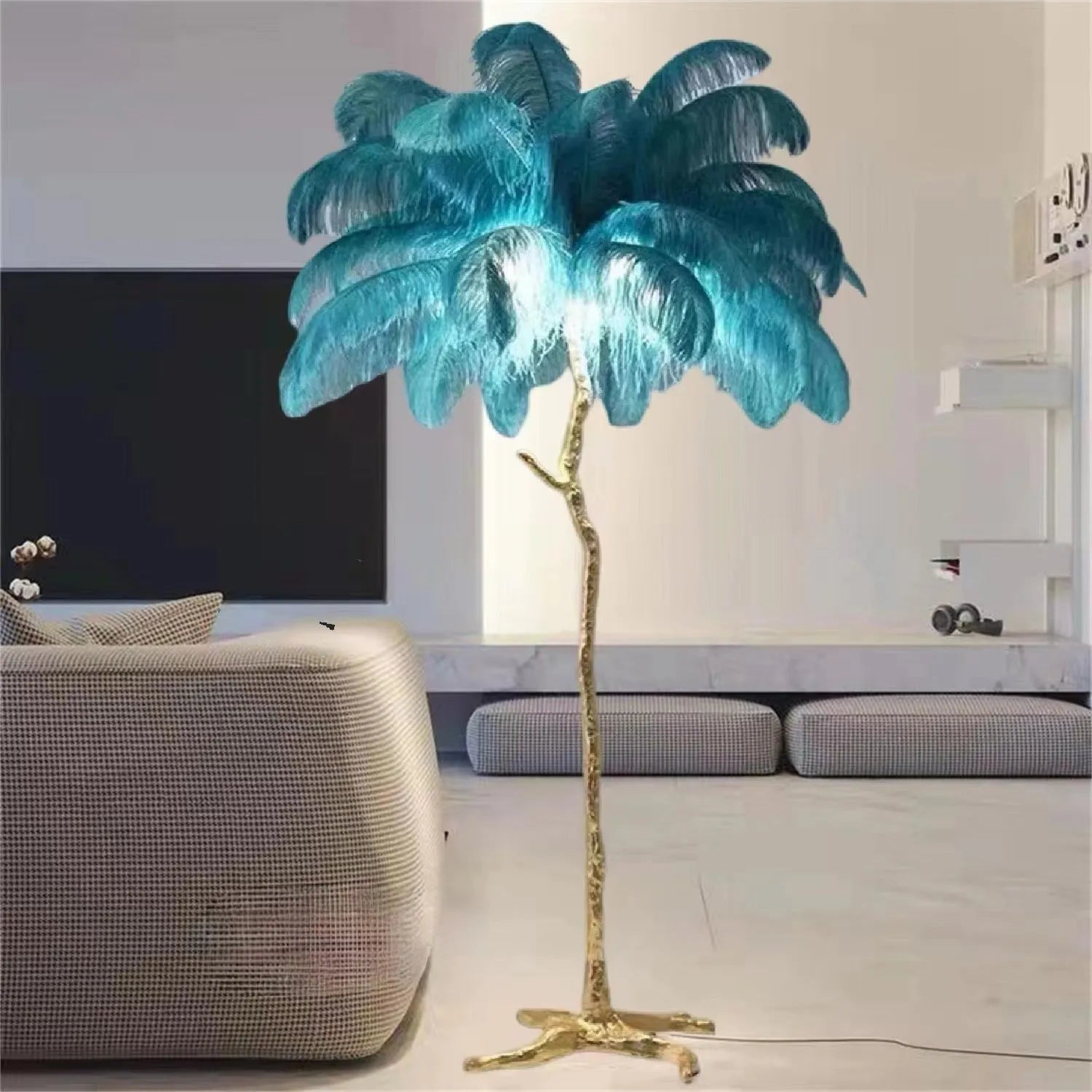 Tall decorative floor lamp with many white resin feathers and a dark base on a wooden floor.