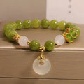 Green tourmaline four leaf clover women's bracelet with safety buckle, peace buckle, and lucky bag charm in New Chinese style.