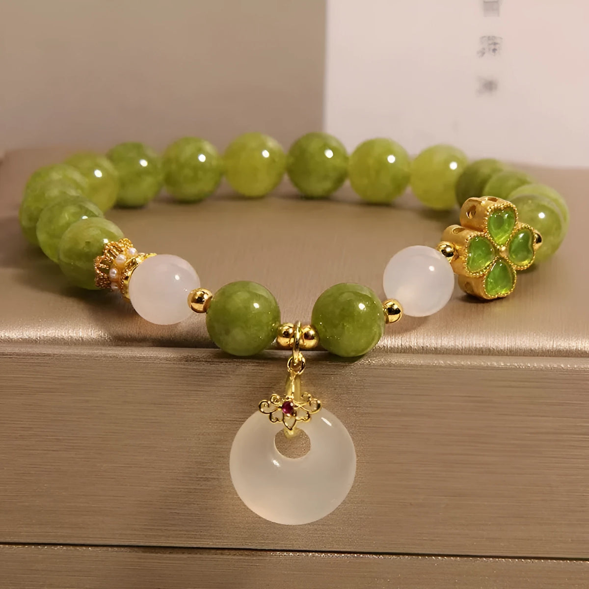 Green tourmaline four leaf clover women's bracelet with safety buckle, peace buckle, and lucky bag charm in New Chinese style.