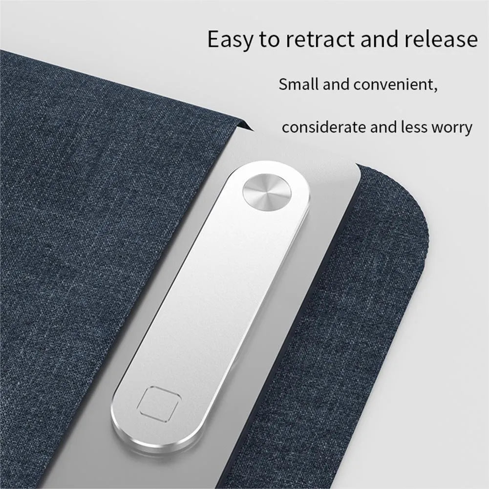 Black aluminium magnetic phone holder mounted on side of laptop screen with smartphone attached.