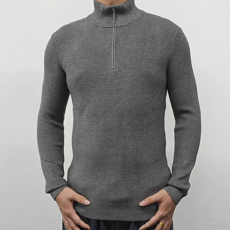 A man's grey half turtleneck zip sweater made from a cotton blend fabric, shown on a hanger.