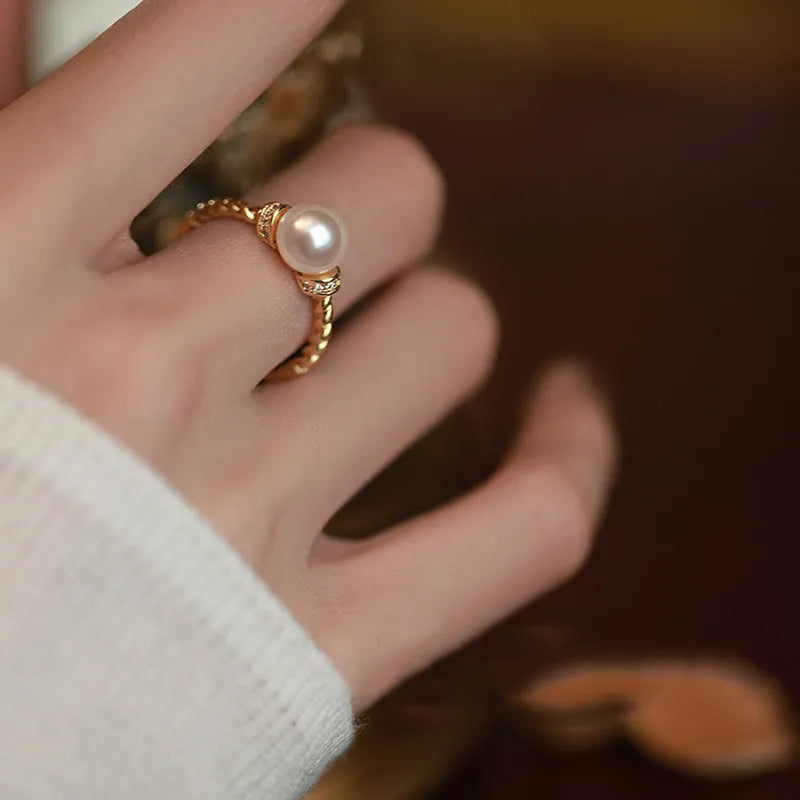 Geometric twist pearl ring with adjustable copper construction in gold colour
