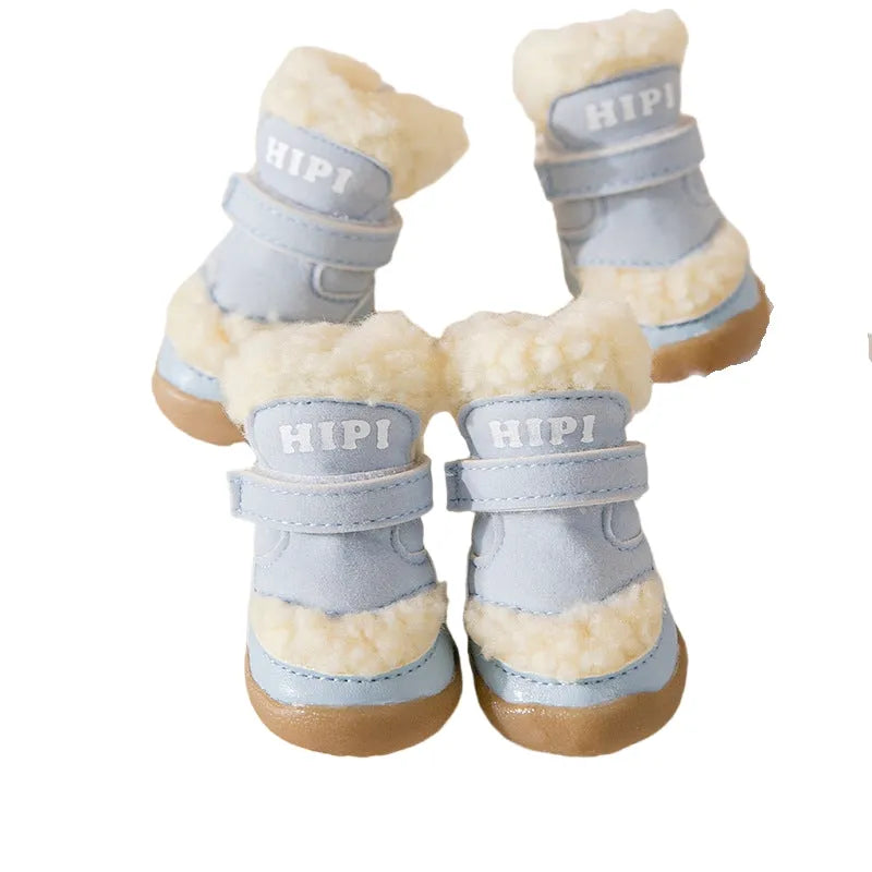 Brown winter dog shoes with adjustable Velcro straps and anti-slip rubber soles on a snowy surface