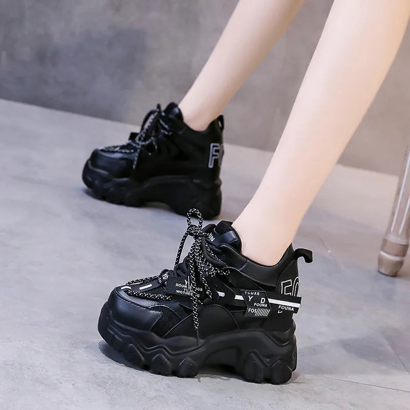 White women's low-top platform trainers with breathable mesh and a black cross-strap.