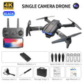 Folding quadcopter drone with dual 4K cameras in black plastic body on flat surface
