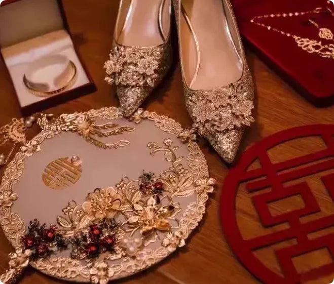 Champagne-coloured women's bridal shoes with rhinestone details, pointed toe, and a fine heel.