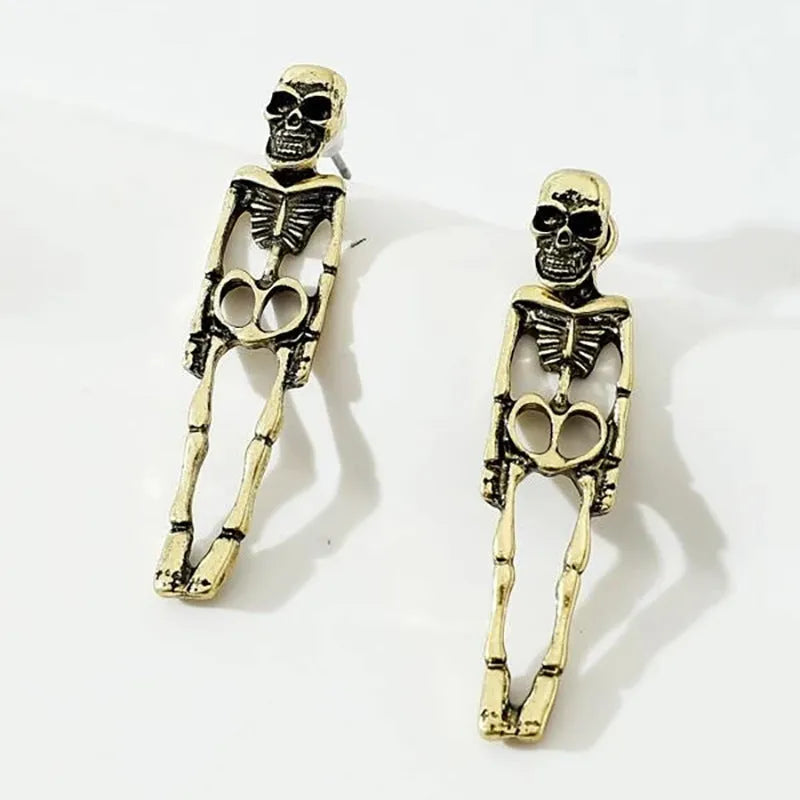 Gold and silver skull detachable stud earrings with skeleton design on white background