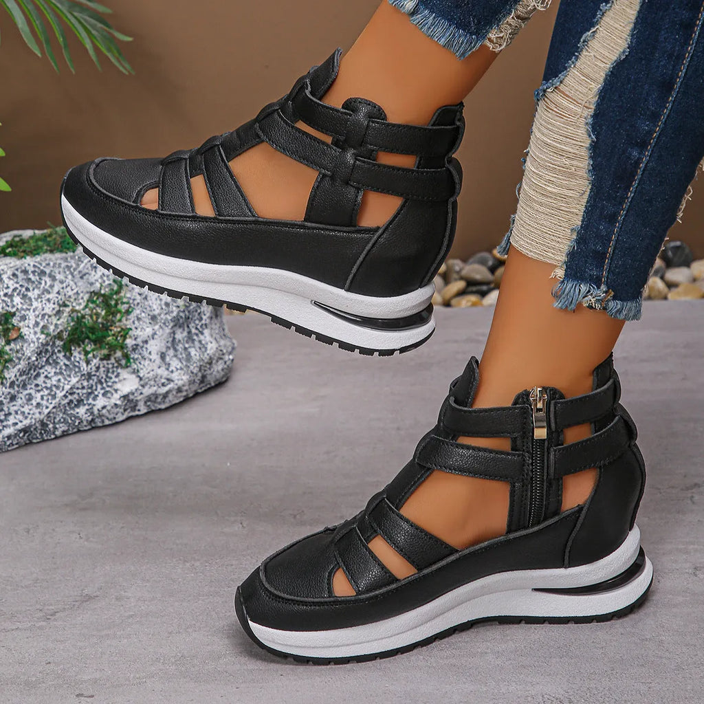 Black women's platform sandals with close toe, hollow-out sides, and a Velcro strap.