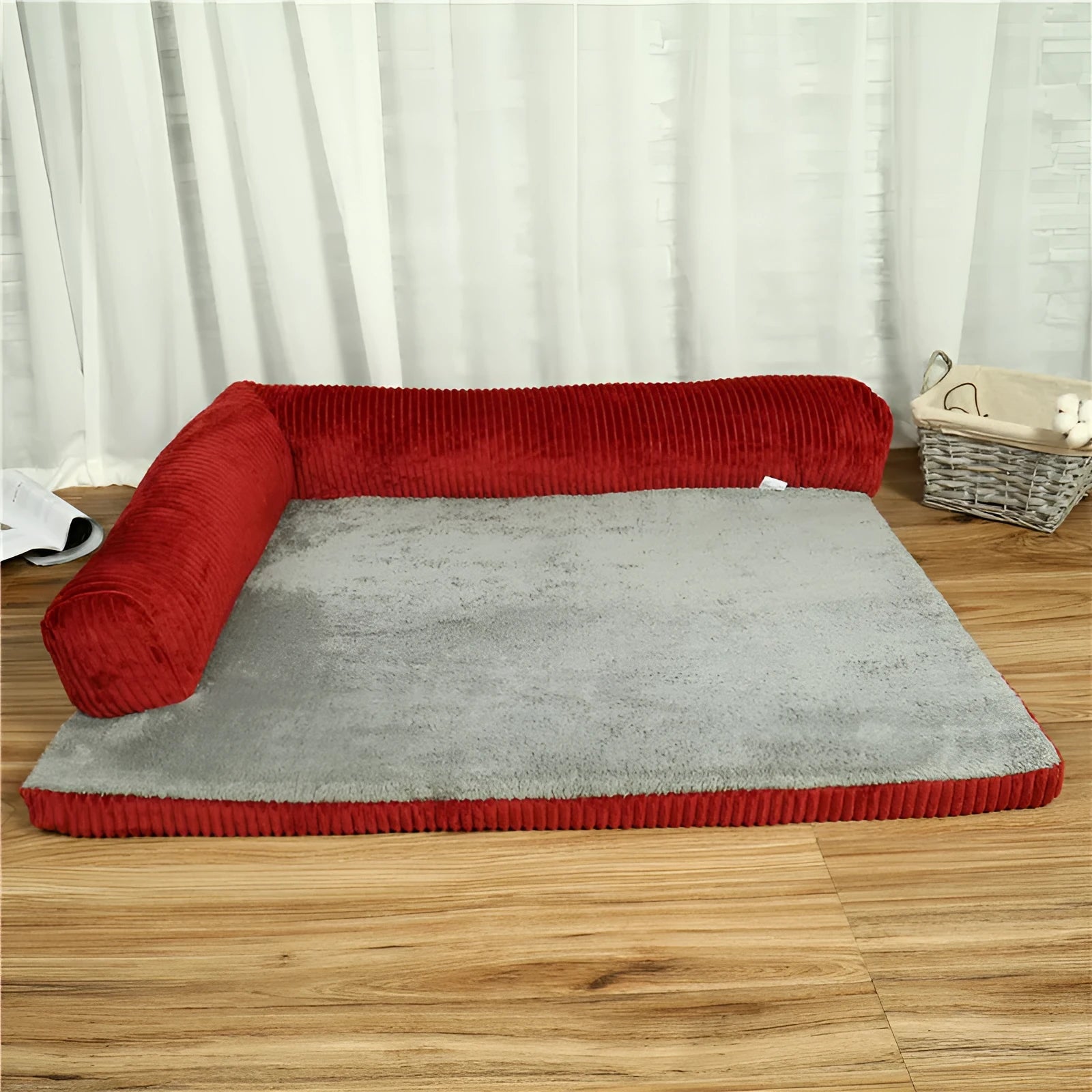 Corduroy pet dog sofa bed in grey colour with a bilateral bolster, shown on a wooden floor.