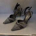 Women's black hollow stiletto heel pumps with a red sole and pointed toe.