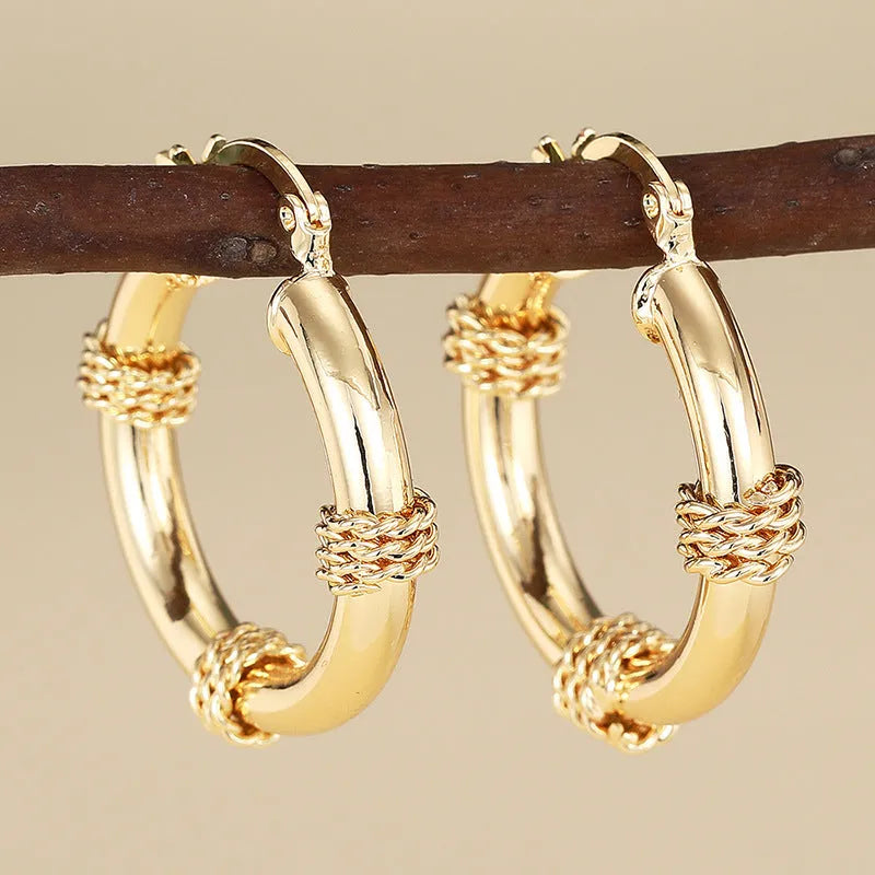 Women's geometric copper earrings with clip-on design in golden colours featuring ring and line elements