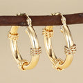 Women's geometric copper earrings with clip-on design in golden colours featuring ring and line elements