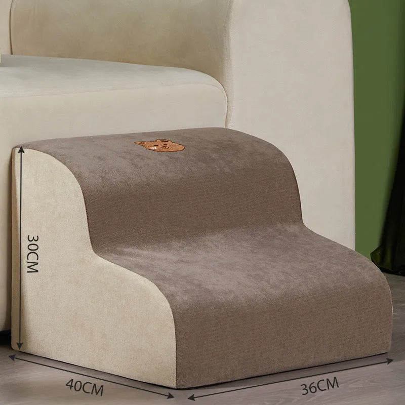 Brown foam pet ramp stairs with non-slip surface on a carpeted floor