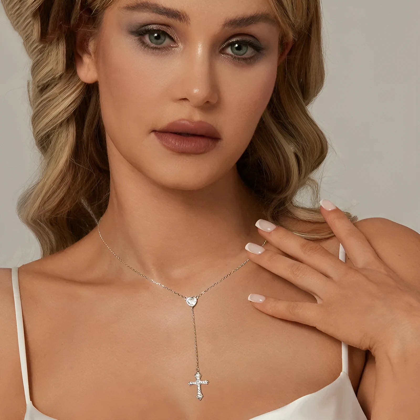 Silver necklace with a small cross pendant on an O-ring chain, shown in colour BSN384.
