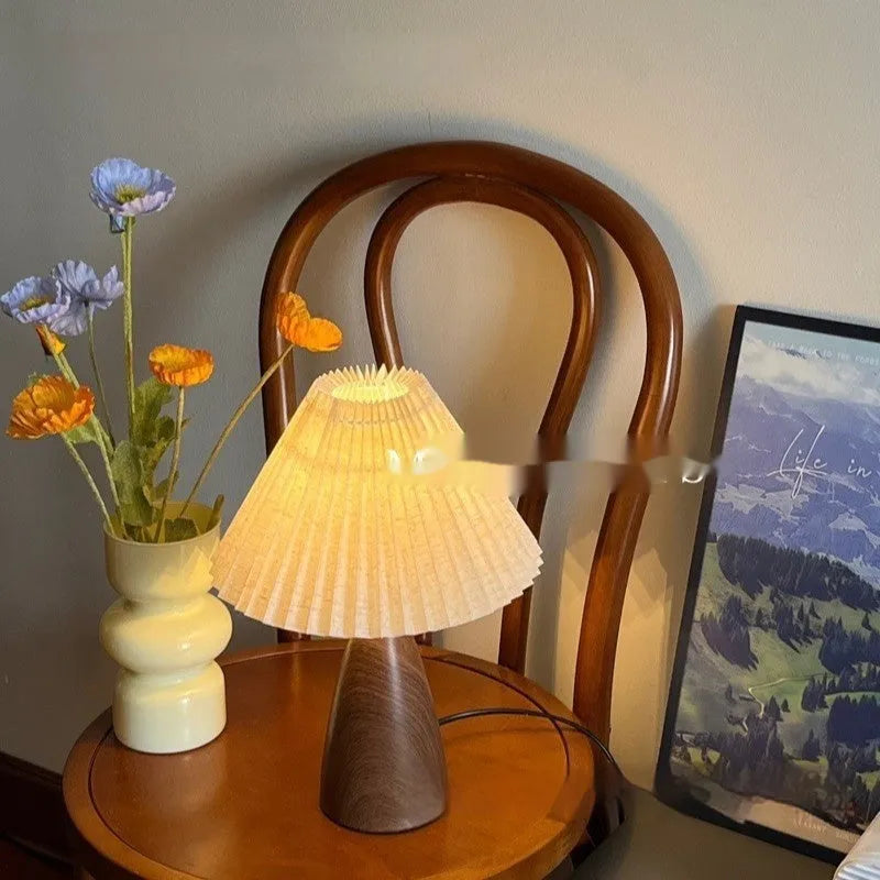 Nordic retro ceramic table lamp with pleated fabric shade and remote control on a bedside table