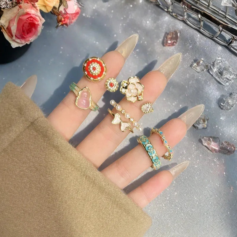 Adjustable copper ring with vintage gourd, flower and bow designs featuring inlaid zircon accents