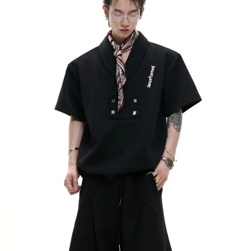 Men's dark grey cotton sports suit with V-neck short sleeve top featuring padded shoulders and metal embellishments with matching shorts