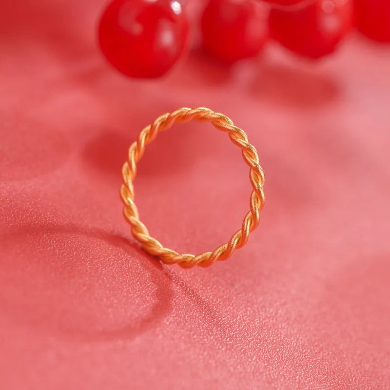 Brass gold plated women's ring showing twist, matte and glossy simple bracelet styles