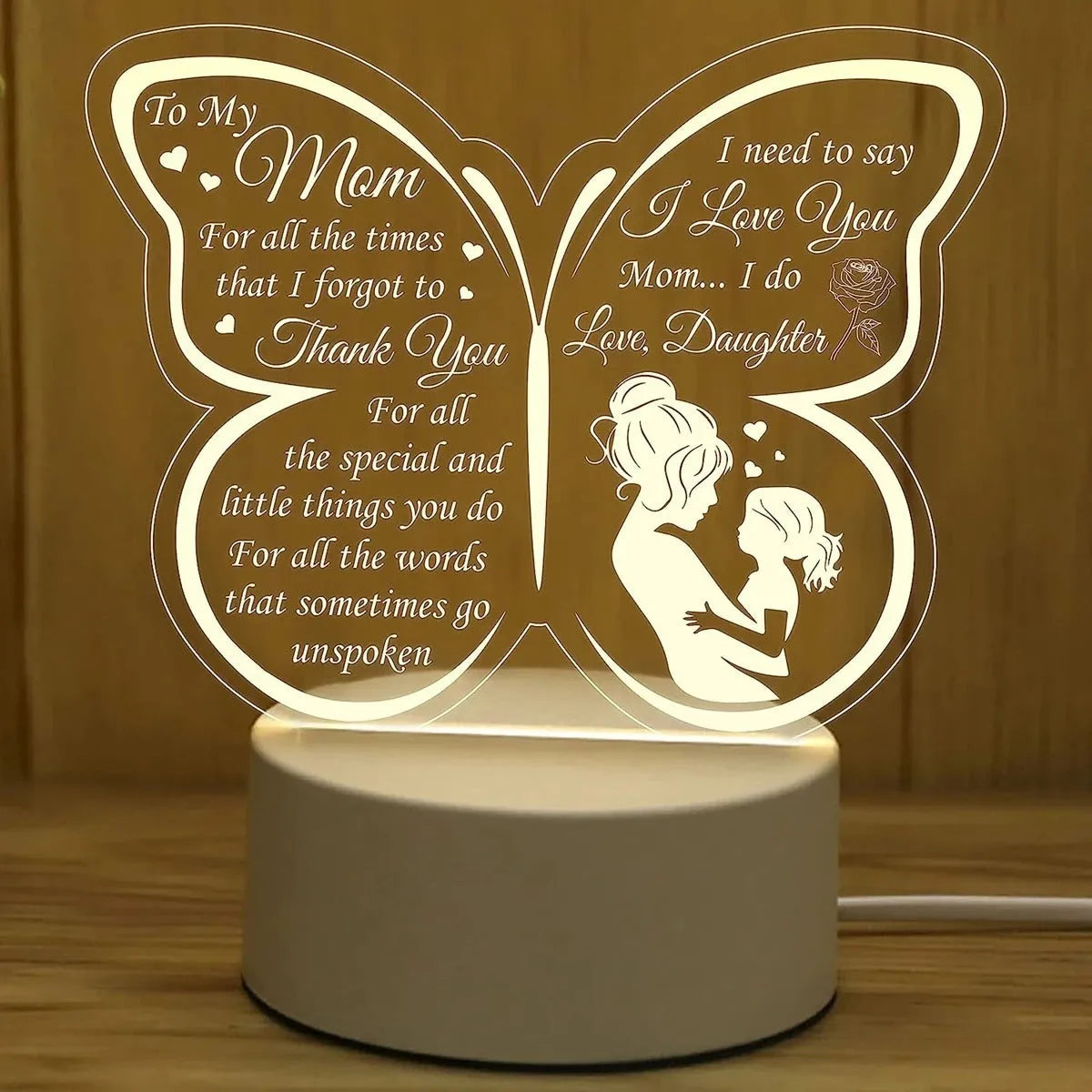 White heart-shaped acrylic table lamp with a touch switch base on a wooden surface.
