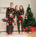 Family Christmas matching cotton pajamas set showing Dad, Mum, child, baby, and dog in coordinated festive sleepwear