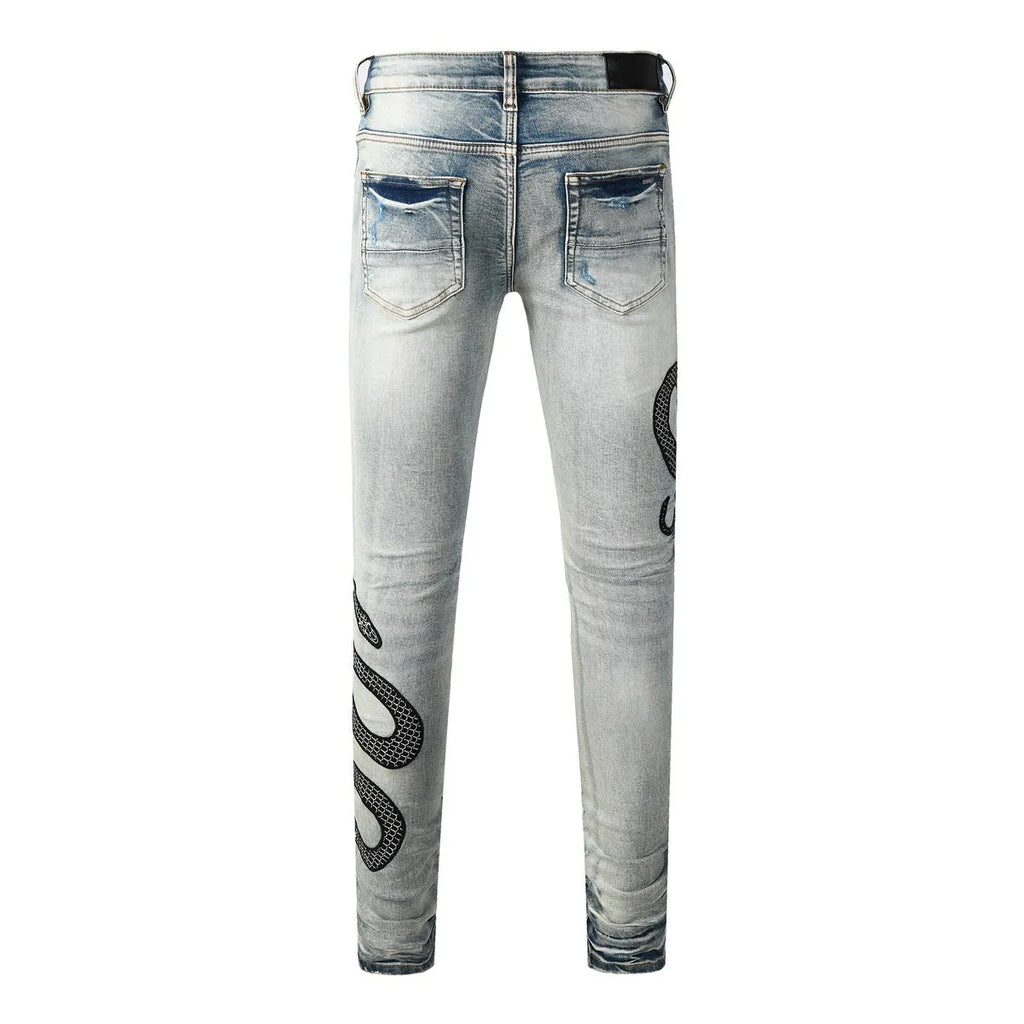 Distressed blue skinny jeans with wash detailing and button fly on mid waist design
