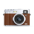 Black or brown 5K digital camera with front and rear lenses and an optical viewfinder on top.