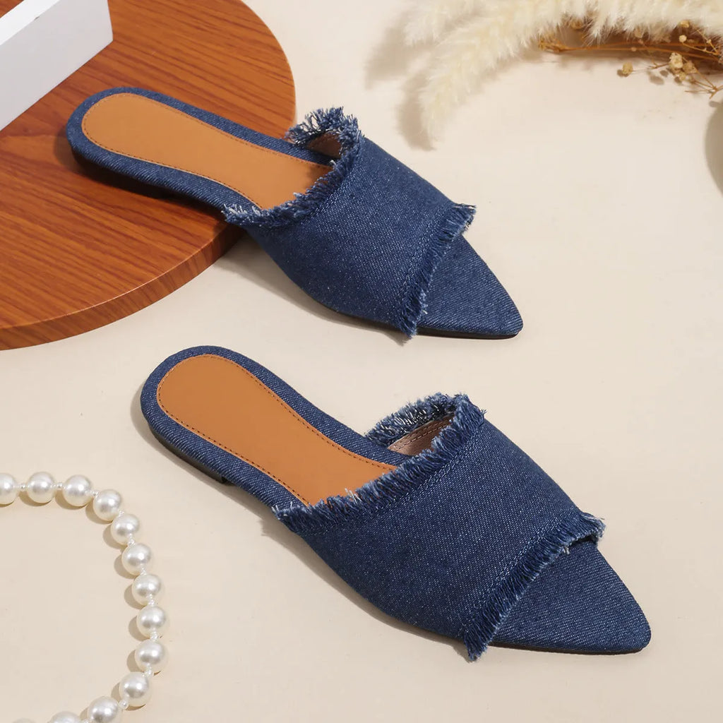 Women's denim casual flat slipper with tassel detail in various colours on a white background.