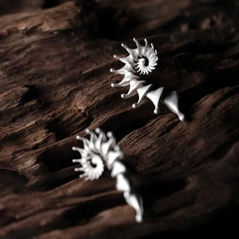Exaggerated three-dimensional matte conch stud earrings with an irregular alloy design.