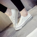Women's casual canvas shoes in solid colours on a flat sole, showing lace-up fastening.