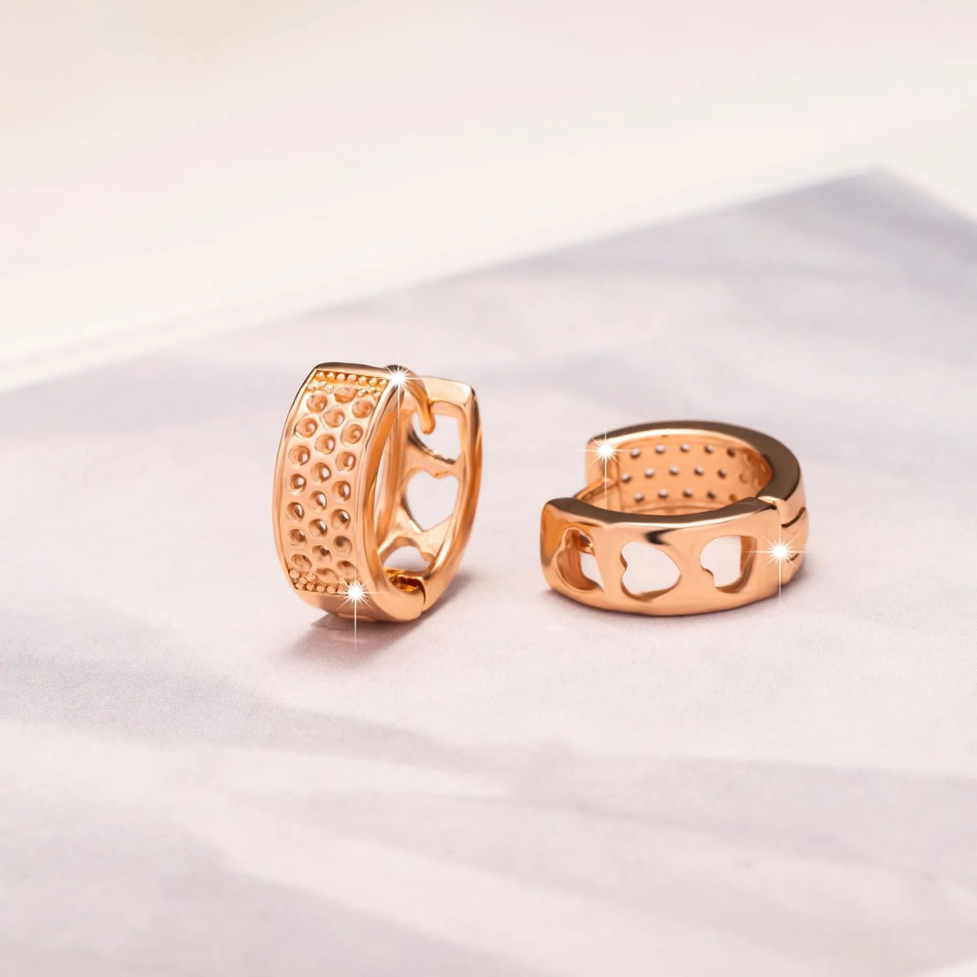Rose gold hollowed heart shaped women's earrings with electroplated finish