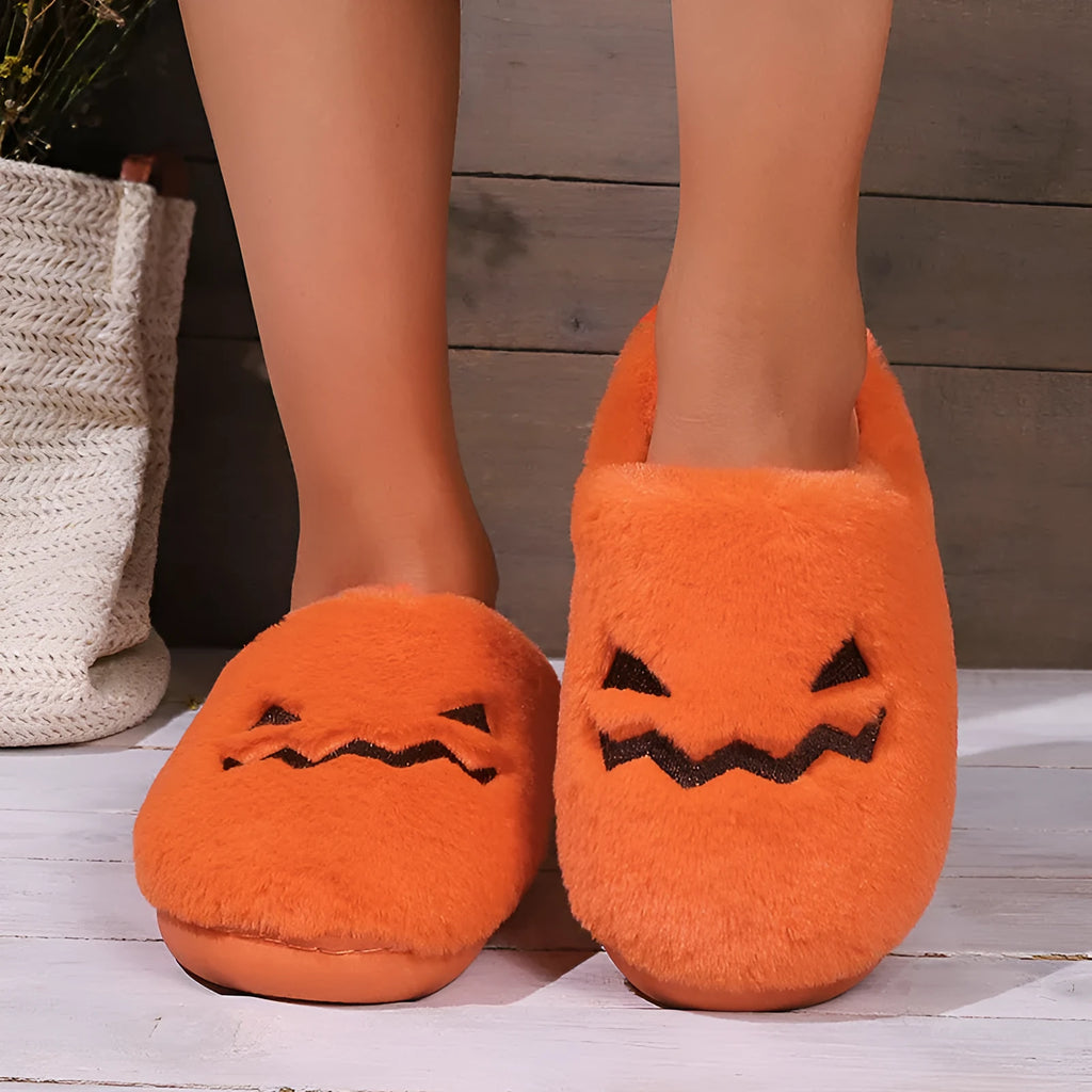 Orange Halloween pumpkin design slippers with plush lining and a textured PVC sole.
