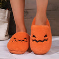 Orange Halloween pumpkin design slippers with plush lining and a textured PVC sole.