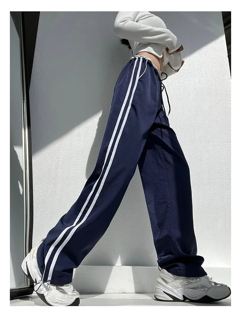 Women's loose straight-leg pants with ribbon parallel bar contrast detailing in navy blue colour option